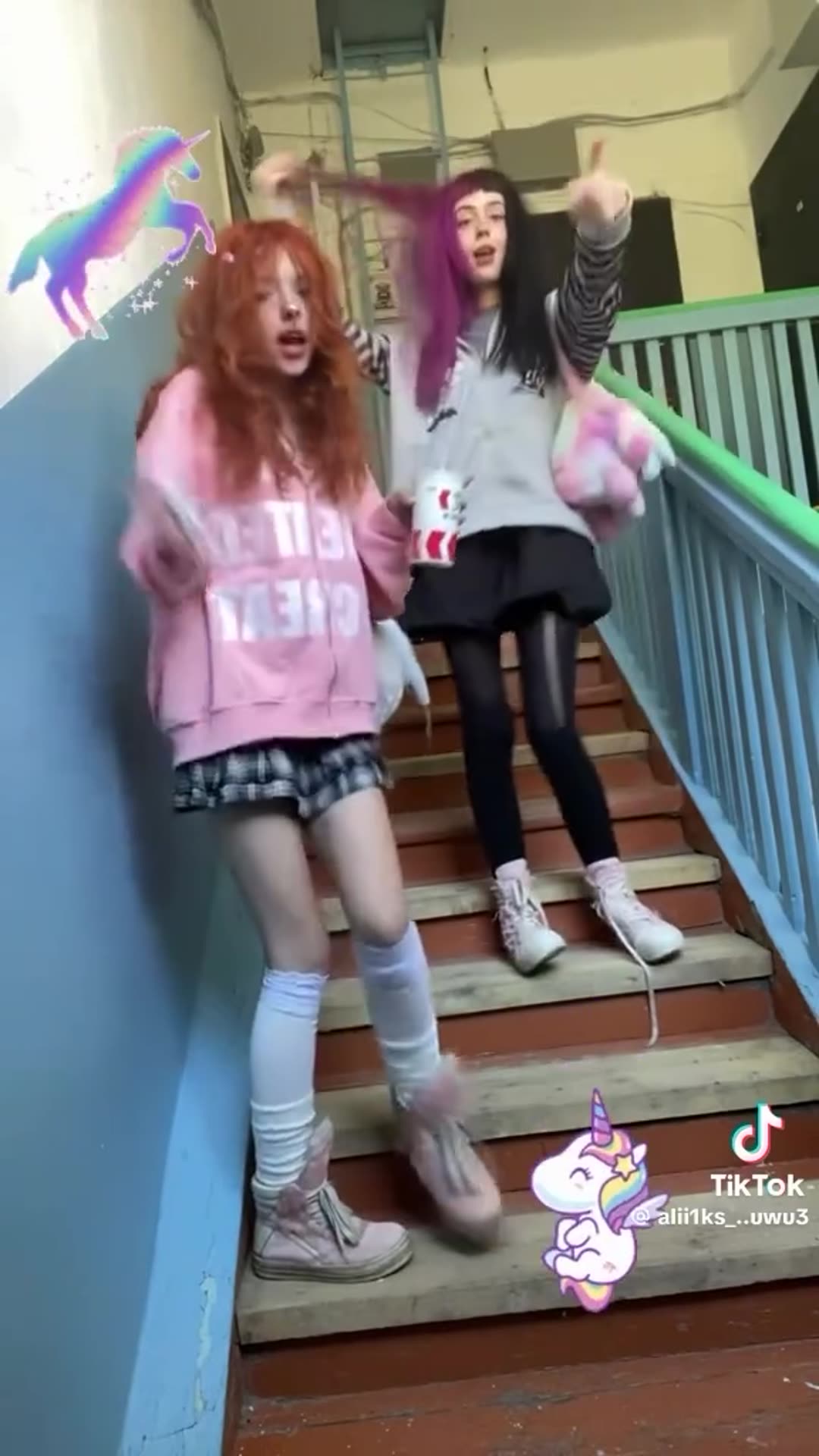A reposted TikTok clip shows two girls dancing and posing on an old stairwell to a pop song, with unicorn stickers and a TikTok watermark, ending on a TikTok search screen.