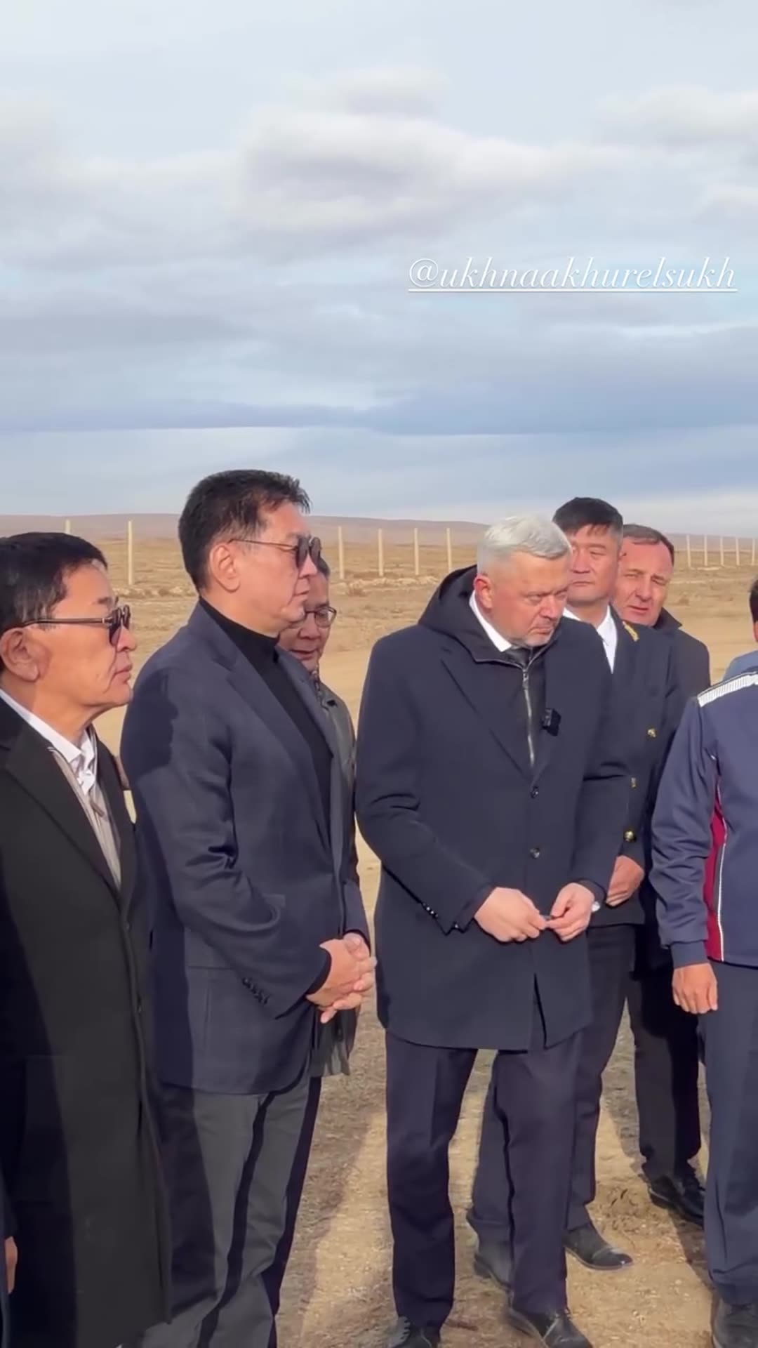 A reshared story shows officials and a delegation standing on open steppe beside a large project information board, while a cameraman films. The overlay text says "Продолжение следует..." (to be continued).