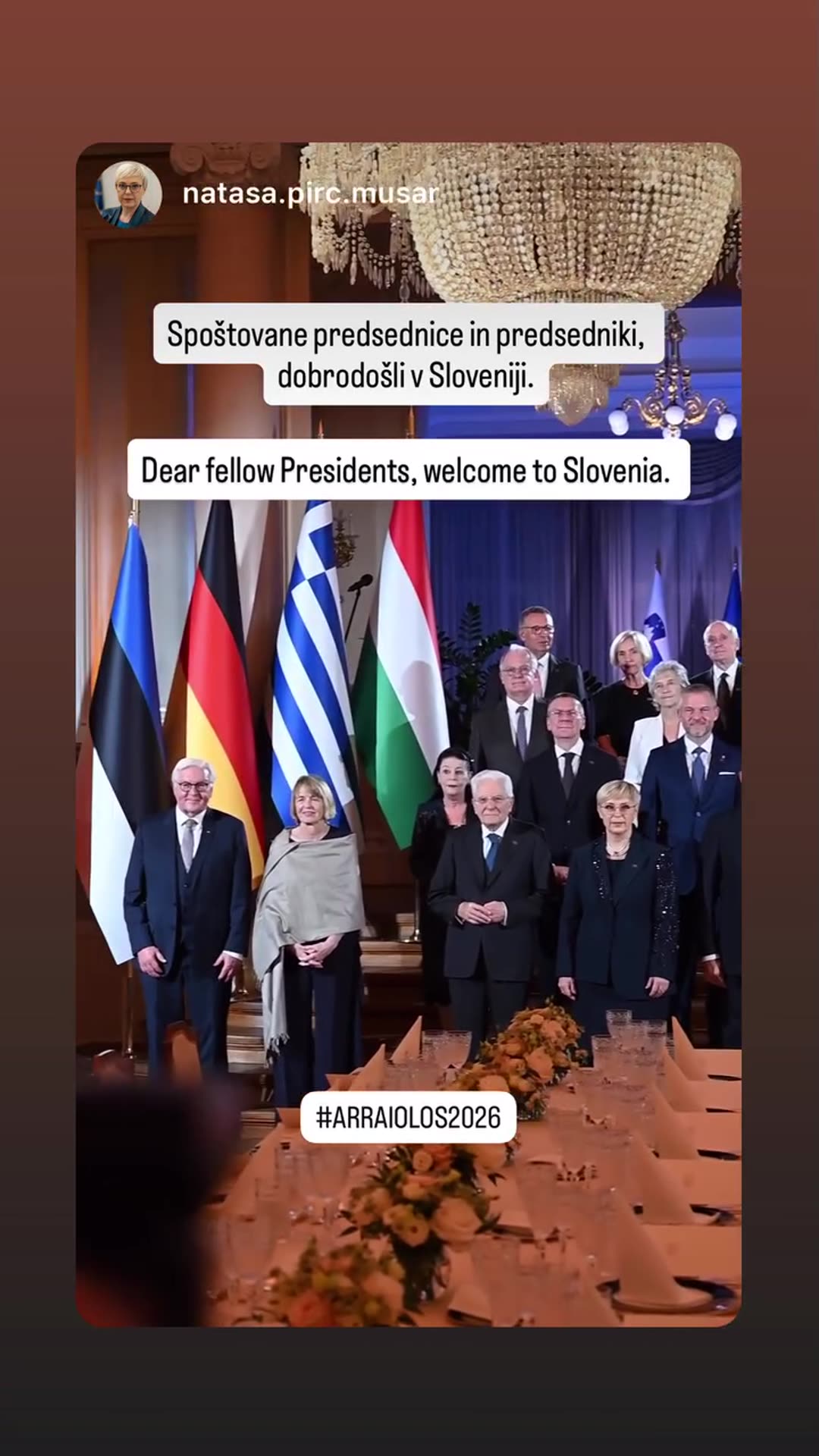 A story reshares a video from Slovenian President Nataša Pirc Musar, shot from behind the audience, that zooms in on the group photo of presidents in a chandeliered hall at the Arraiolos 2026 meeting. Overlay text welcomes fellow presidents to Slovenia, and the owner tagged the German Federal Presi…