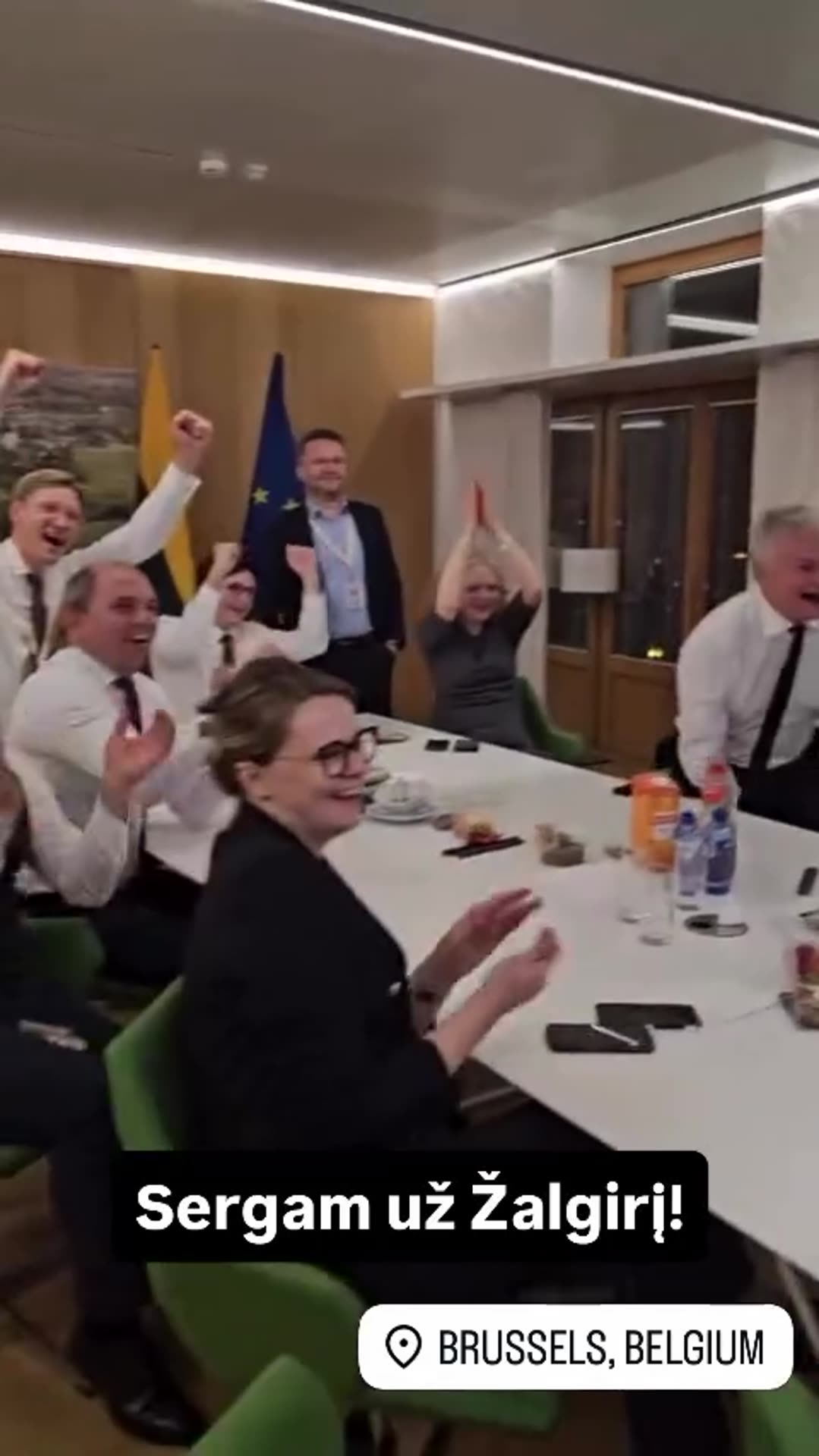 A reshared story from @gitanasnauseda shows a group in a Brussels meeting room watching a Žalgiris basketball game on a large screen and cheering. The overlay reads 'Sergam už Žalgirį!' (We're rooting for Žalgiris).