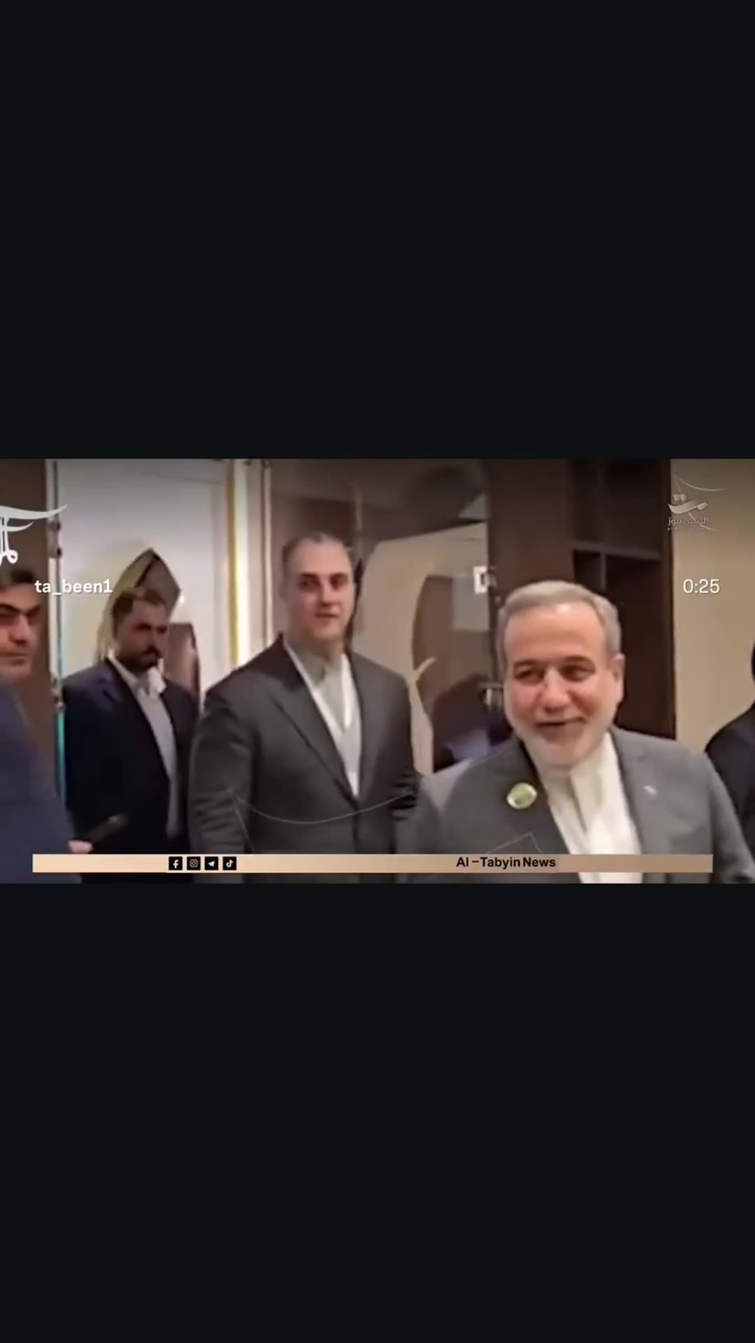 A story reshares an Al-Tabyin News reel showing Iran's foreign minister and Lebanon's foreign minister meeting in Baghdad on the sidelines of an Organisation of Islamic Cooperation foreign ministers' council meeting. The clip shows them walking through a hotel corridor, shaking hands in front of th…