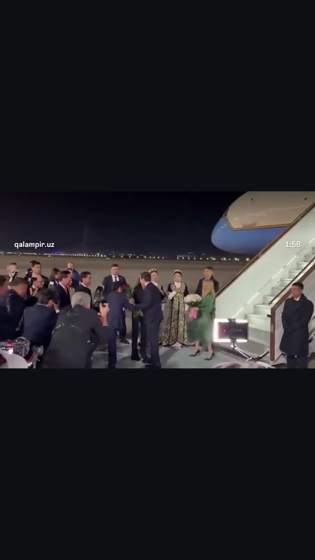 A reshared qalampir.uz video of US Secretary of State Marco Rubio and his wife arriving by plane at Samarkand airport at night and being welcomed by Uzbek officials and women in traditional dress.