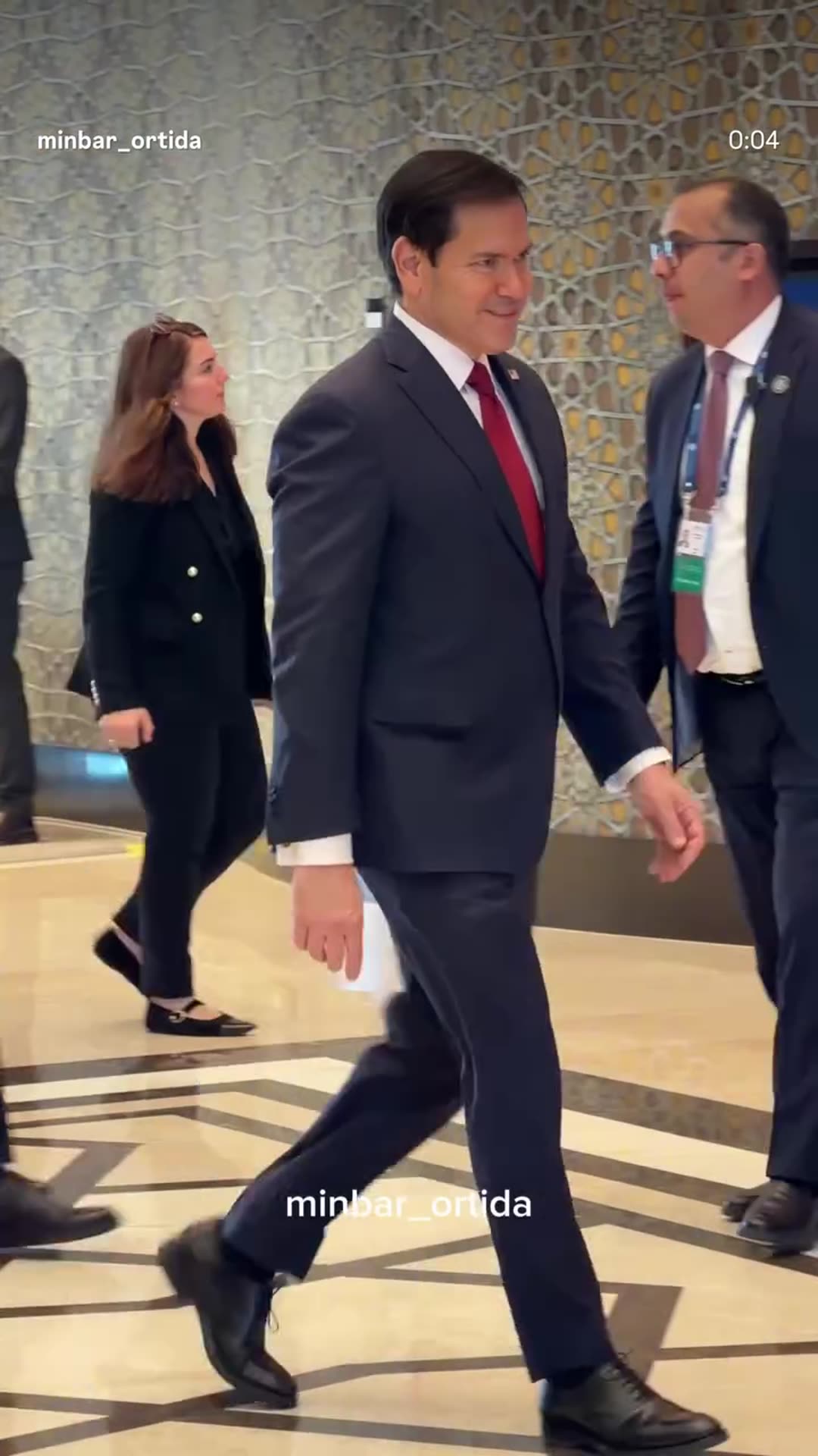 A story reshares a @minbar_ortida reel showing US Secretary of State Marco Rubio walking with his entourage through a hotel or conference hall in Samarkand at the start of his official events. The original caption says the Uzbek head of state is expected to receive him later in the day. The shared…