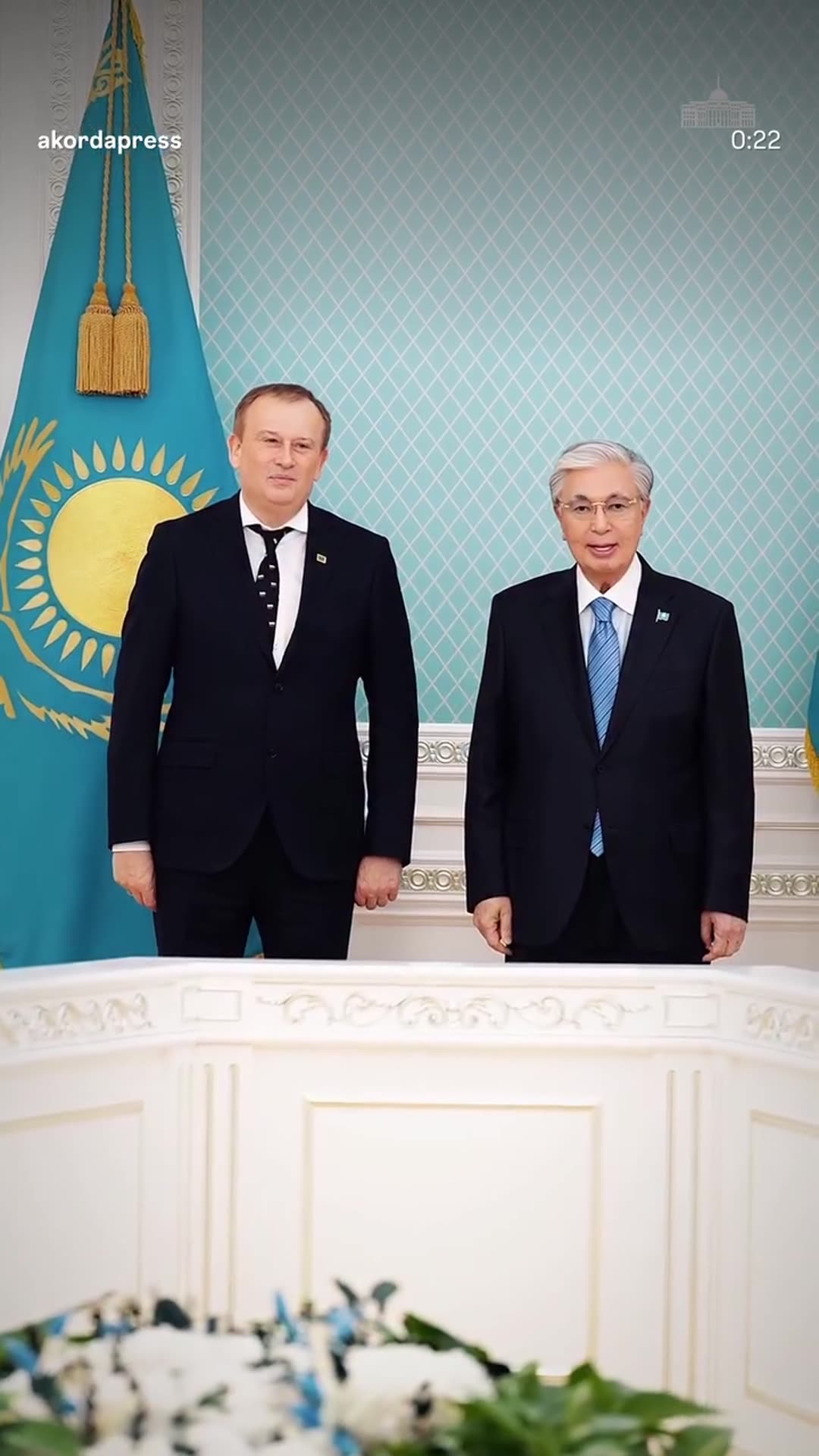 A story reshares an Akorda press reel of a meeting in Kazakhstan with the governor of Leningrad Oblast, showing the formal photo, the negotiating table and a Kazakh state medal that ends up pinned on the governor's lapel.