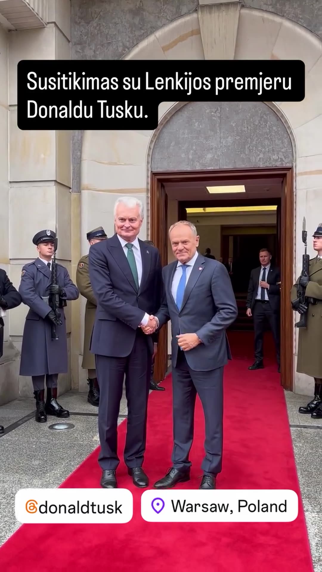 A reshared story shows a ceremonial welcome at the Polish Chancellery in Warsaw. The Lithuanian visitor is greeted by Polish Prime Minister Donald Tusk on a red carpet in front of an honor guard, and the two shake hands for photographers.