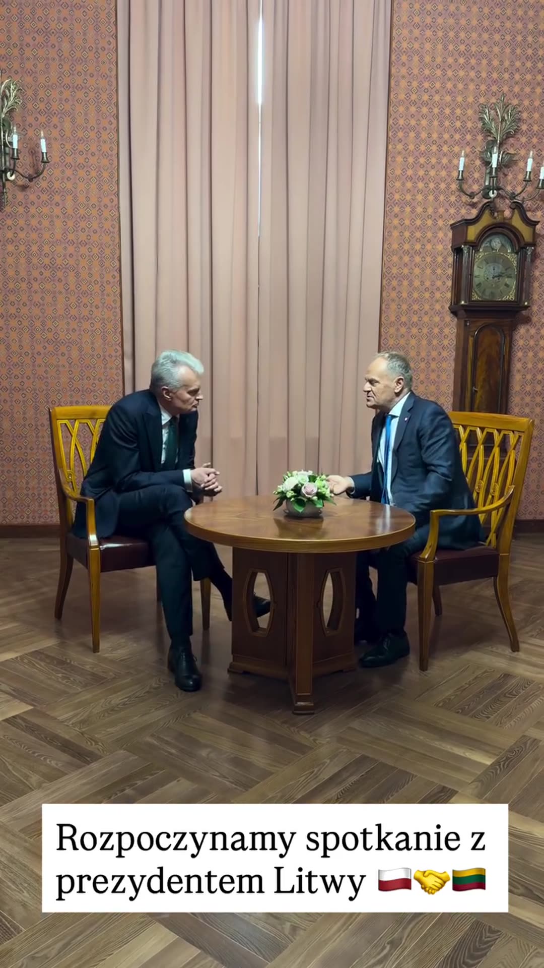 A story reshares Donald Tusk's short video of the start of a meeting with the President of Lithuania. Two men sit across a small round table with flowers and talk.