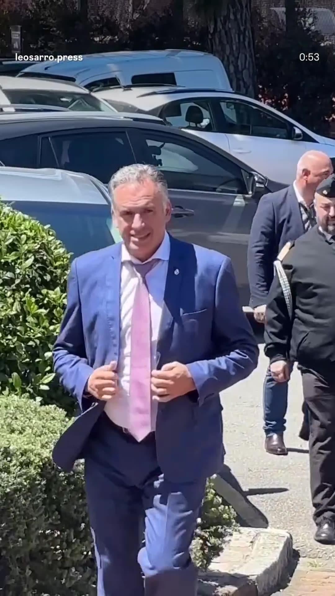 A story reshares a Leo Sarro Press reel of President Orsi arriving at the Montevideo golf club for the Construction Day lunch, being greeted at the door by men in suits while the press films.