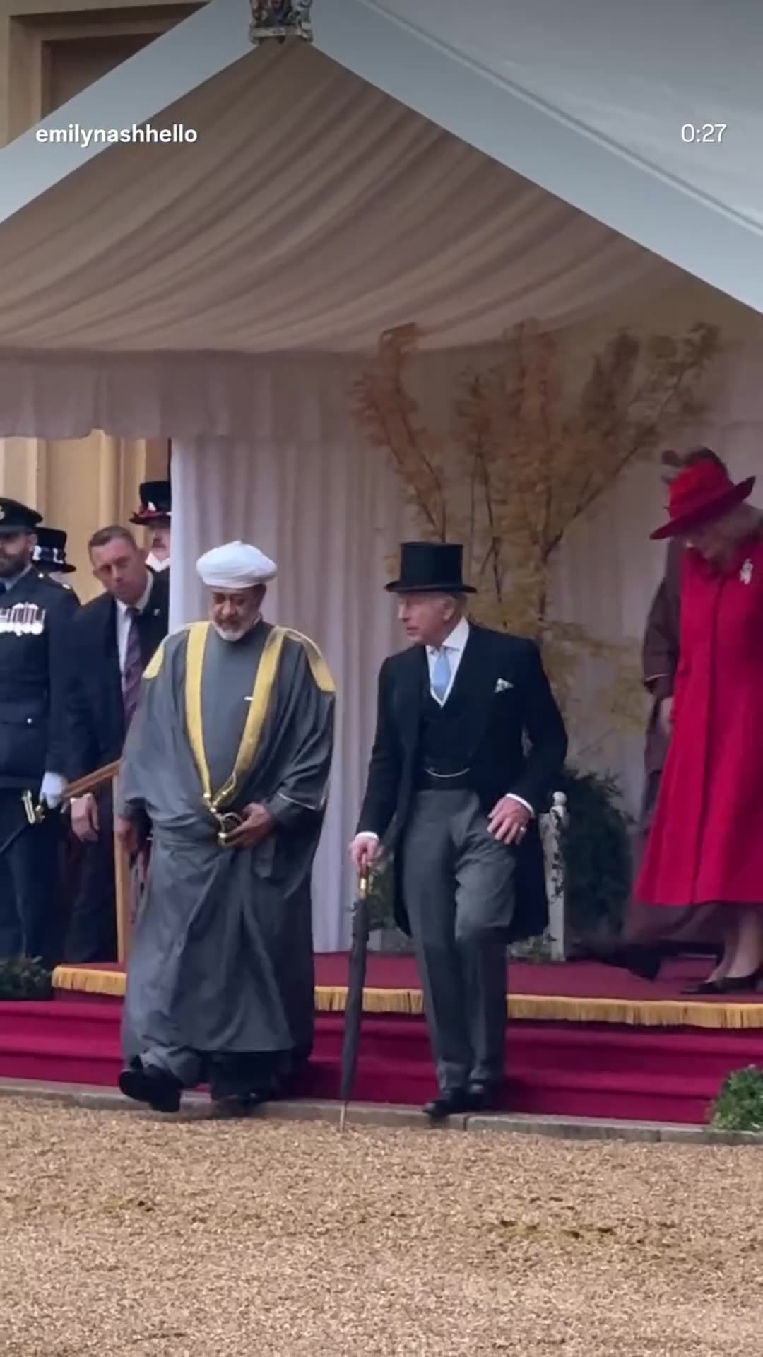 A story reshares Emily Nash's reel of the Sultan of Oman walking with the King, Queen and the Prince and Princess of Wales at the ceremonial welcome at Windsor on a wet day, ahead of the State Banquet. The footage follows the party across the gravel past ceremonial guards. A feed-media sticker show…