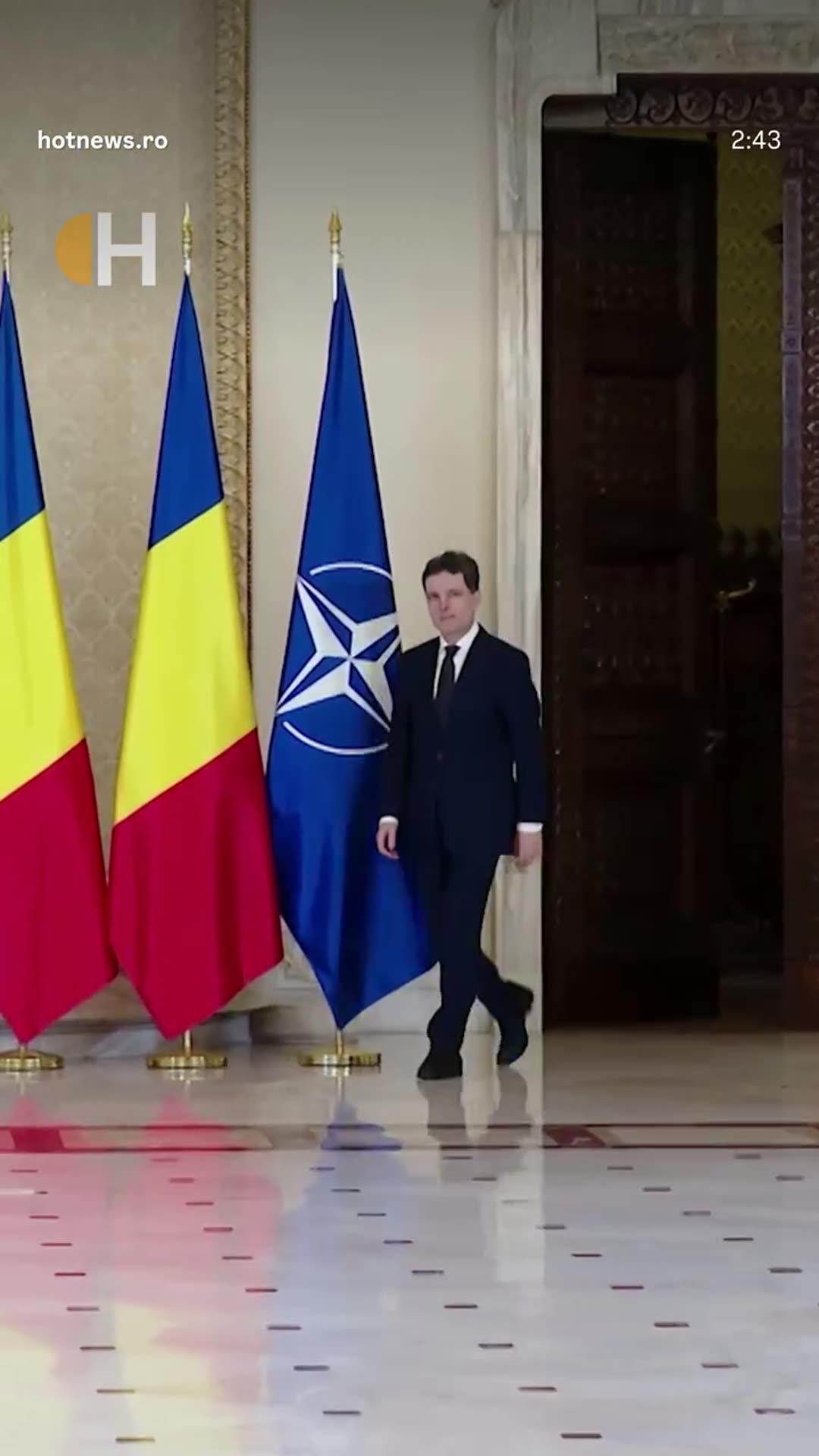 A story reshares a hotnews.ro reel of the swearing-in ceremony for Romania's new prime minister. The reel shows him entering past Romanian and NATO flags, the cabinet lined up, the oath being recited and a document being signed.