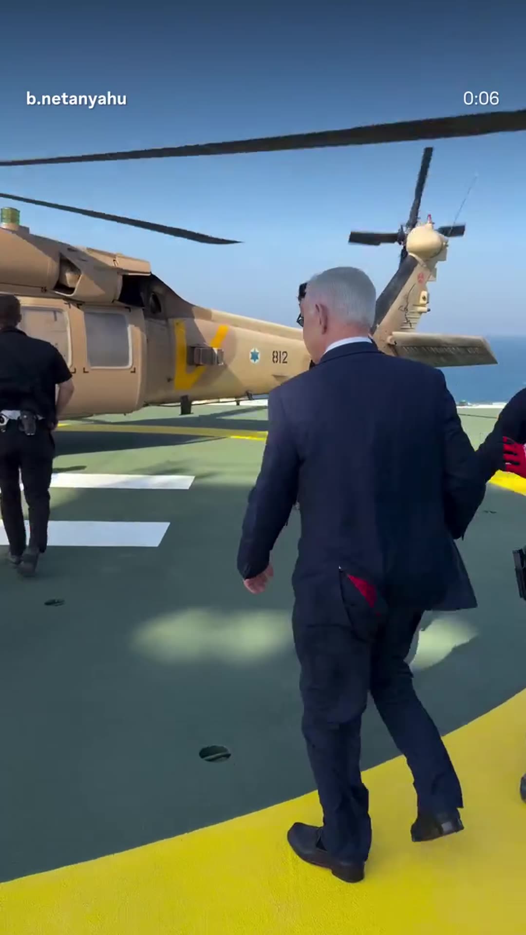 A story reshares an Instagram reel from @b.netanyahu showing a man in a suit walking across a helipad and boarding a tan military helicopter, set to AC/DC's Thunderstruck. The story overlays the reel as a feed-media sticker over a copy of the video.