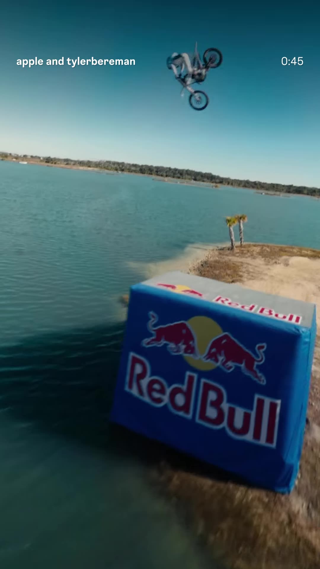 A story reshares Apple's Island Hopper reel, shot on iPhone 17 Pro. A rider jumps motocross bikes across six small islands linked by floating ramps over a lake. The clip ends with a celebratory selfie with the crew.