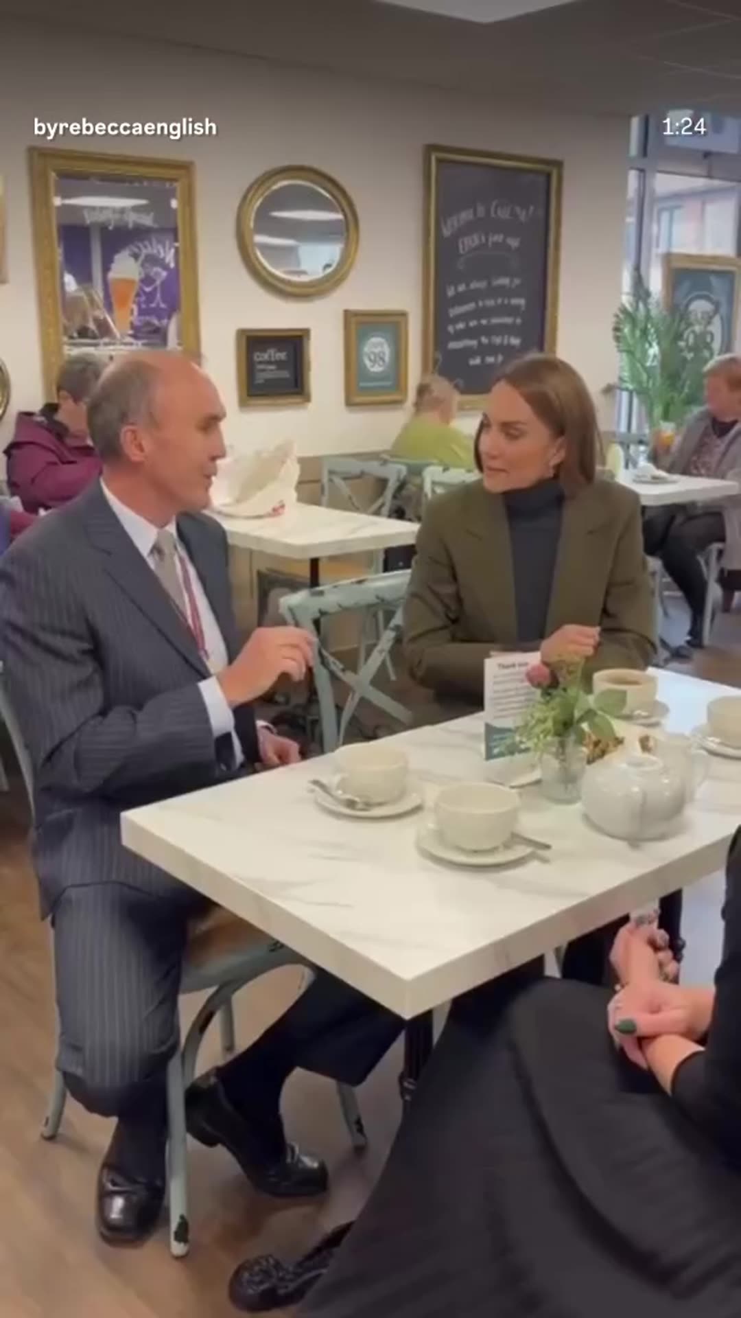 A story reshares Rebecca English's reel of the Princess of Wales's surprise visit to Café 98, a charity shop and cafe in Hoveton, Norfolk. She chats with customers over tea, talks with cafe staff, helps a volunteer sort donated clothes, and greets a crowd outside.
