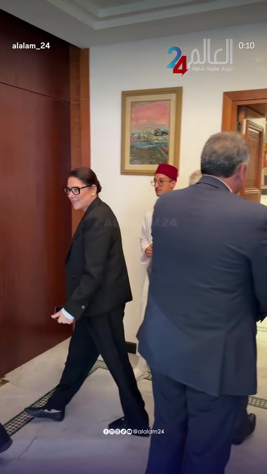 A story reshares an Al Alam 24 reel showing the head of government arriving at the Moroccan parliament, greeting officials in the corridor and being led to the session hall for the debate on the government programme.