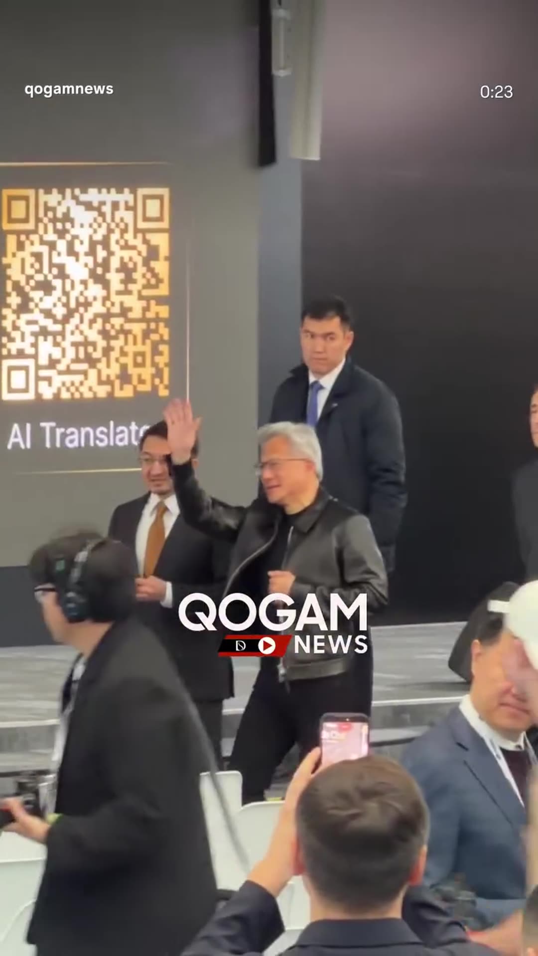 A reshared news reel shows the arrival of Jensen Huang and Zhaslan Madiyev at Alem.ai. The visitors are walked past the AI and robotics demonstrations and through the hall of white chairs, ahead of a planned fireside chat on the future of AI. A quantum-computer-like installation is visible at the e…
