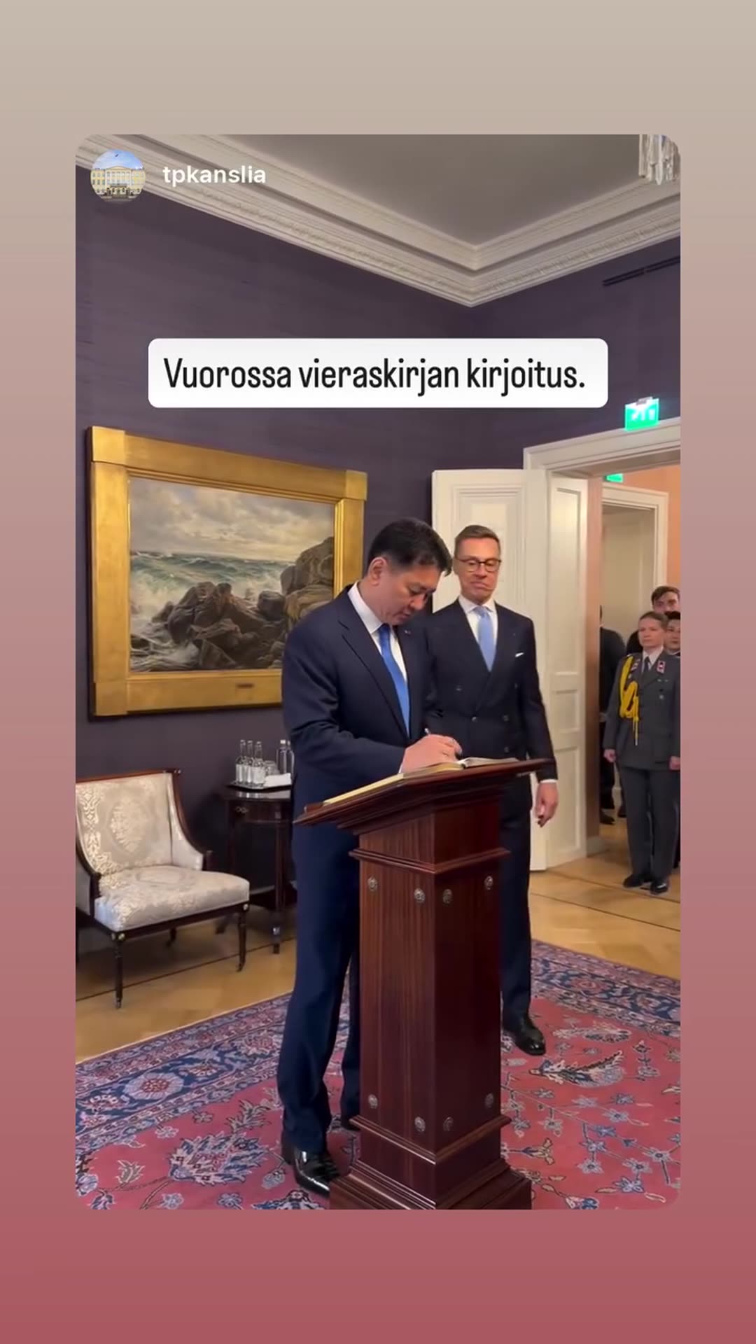 A reshared story from the Finnish President's Office shows a guest book signing during an official visit. A delegation walks through a doorway, and the visiting leader writes in the book at a wooden lectern while the host looks on.