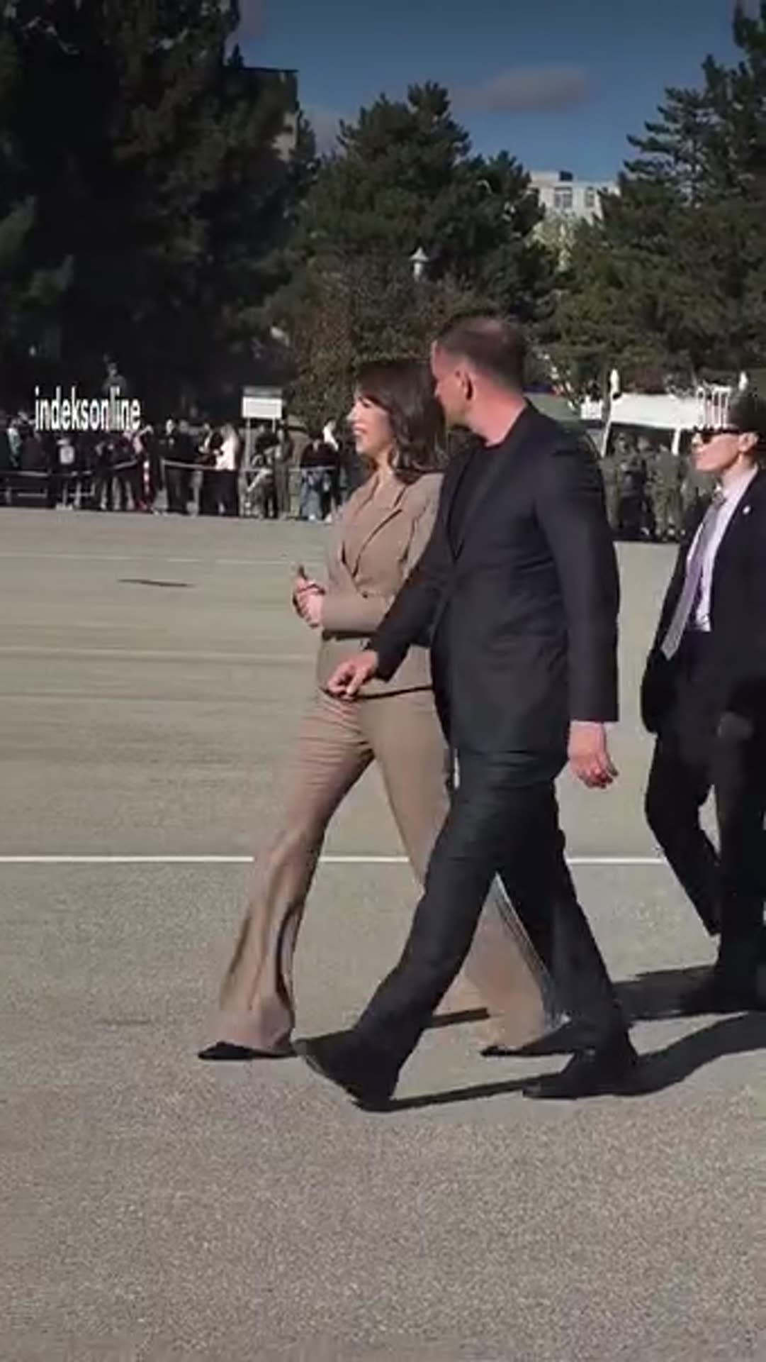 A story reshares an IndeksOnline reel of the Speaker of the Assembly, Albulena Haxhiu, arriving at the FSK (Kosovo Security Force) base. She is escorted across a parade ground past a ceremonial band, onlookers and military police.