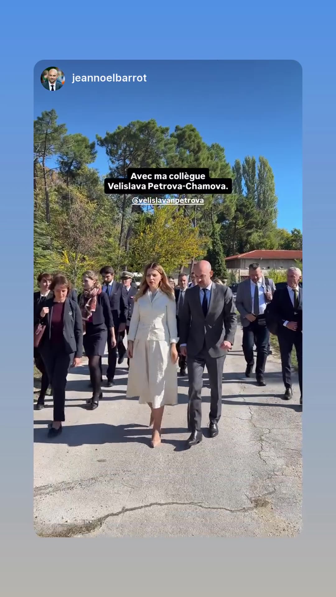 A story reshares a video from Jean-Noël Barrot's account showing him walking with his colleague Velislava Petrova-Chamova and a delegation along a path in a sunny autumn park.