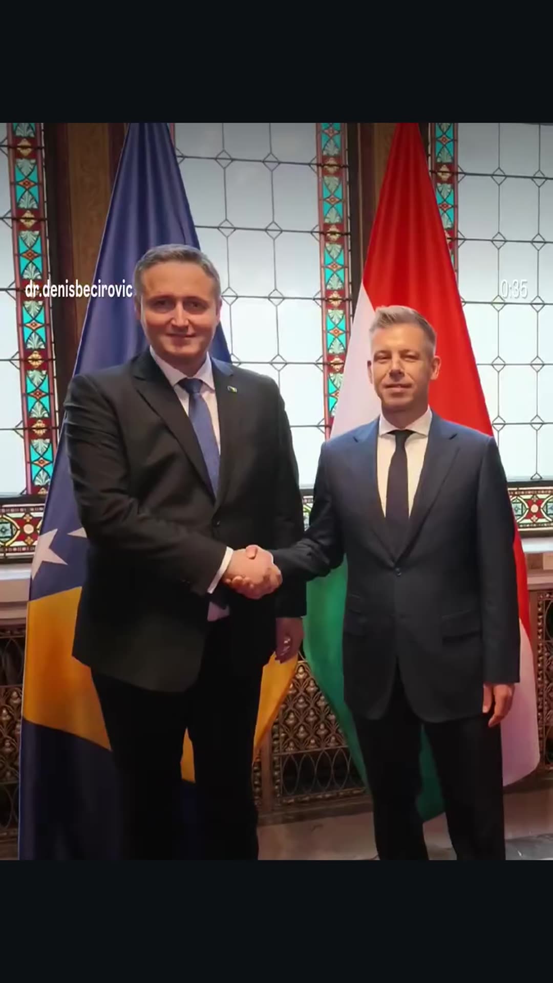 A story reshares dr. Denis Bećirović's reel of his bilateral meeting with Hungarian Prime Minister Péter Magyar in Budapest: a ceremonial welcome, a handshake before the flags, talks at a table, and a viewing of the Holy Crown of Hungary.