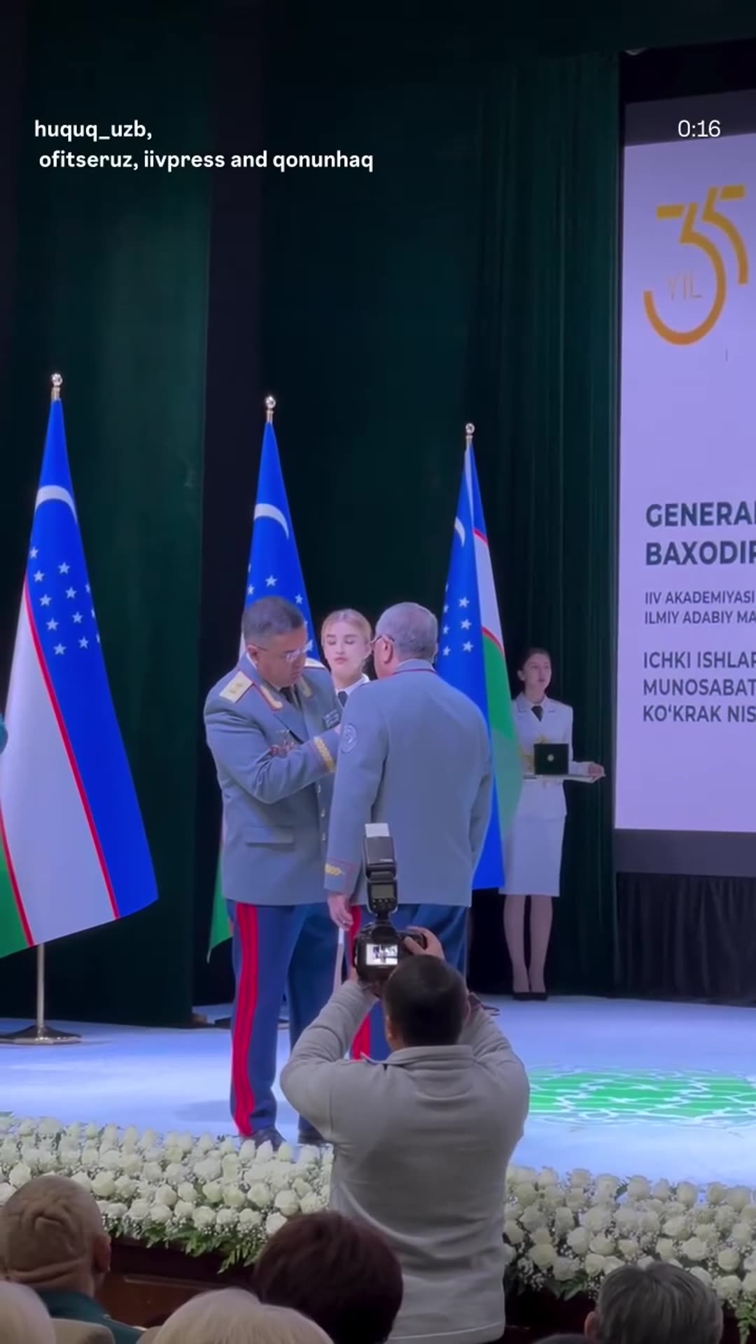 A story reshares a @huquq_uzb reel of a ceremony in which General-Lieutenant Bahodir Matlyubov is awarded the "IIV 35 yilligi" breast badge. A senior officer pins the badge on him, they stand together, and the officer applauds.