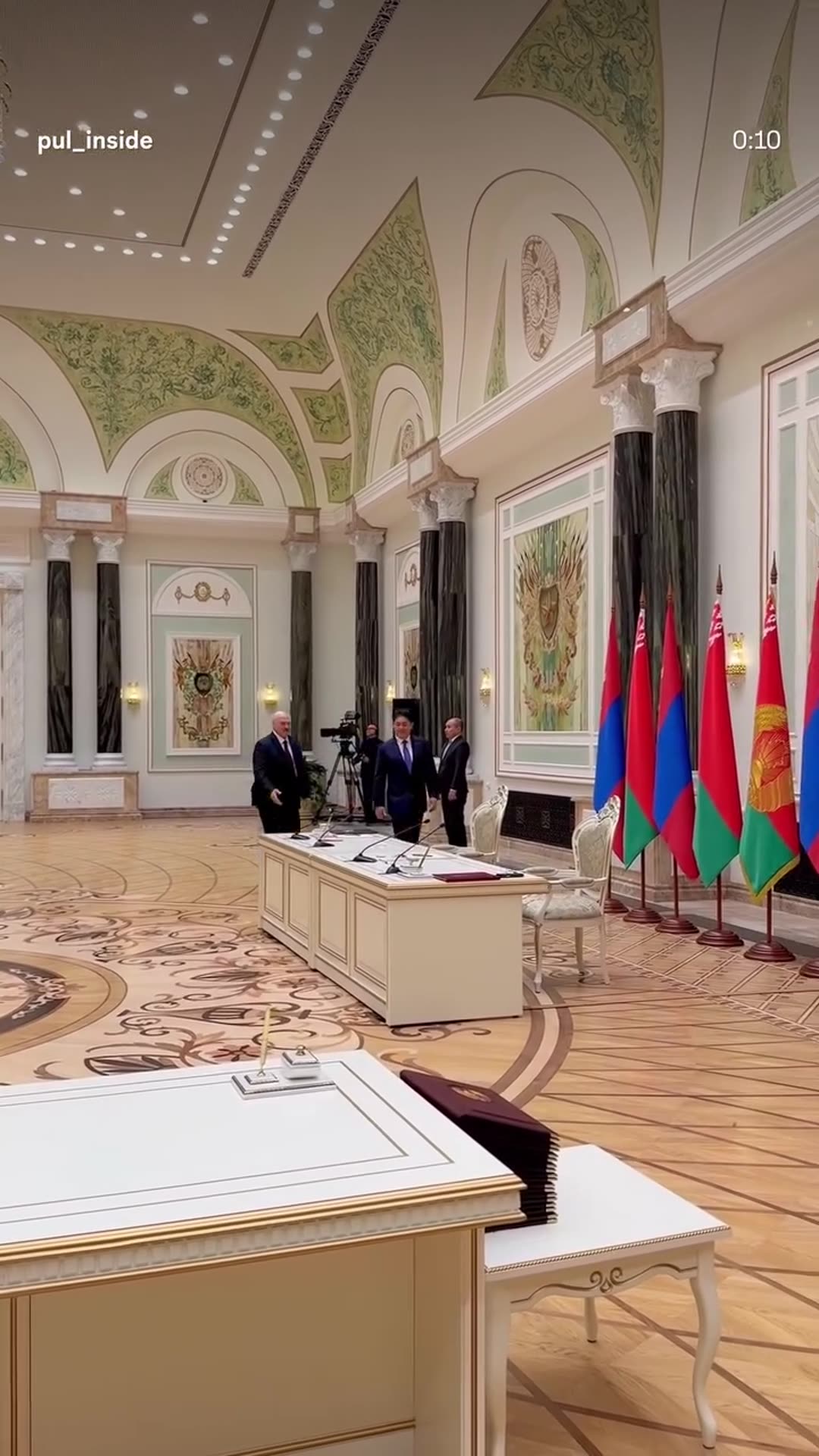 A story reshares pul_inside's reel showing the Belarusian and Mongolian presidents entering the ornate State Awards Hall to sign agreements, with delegations lined up and guards at attention.