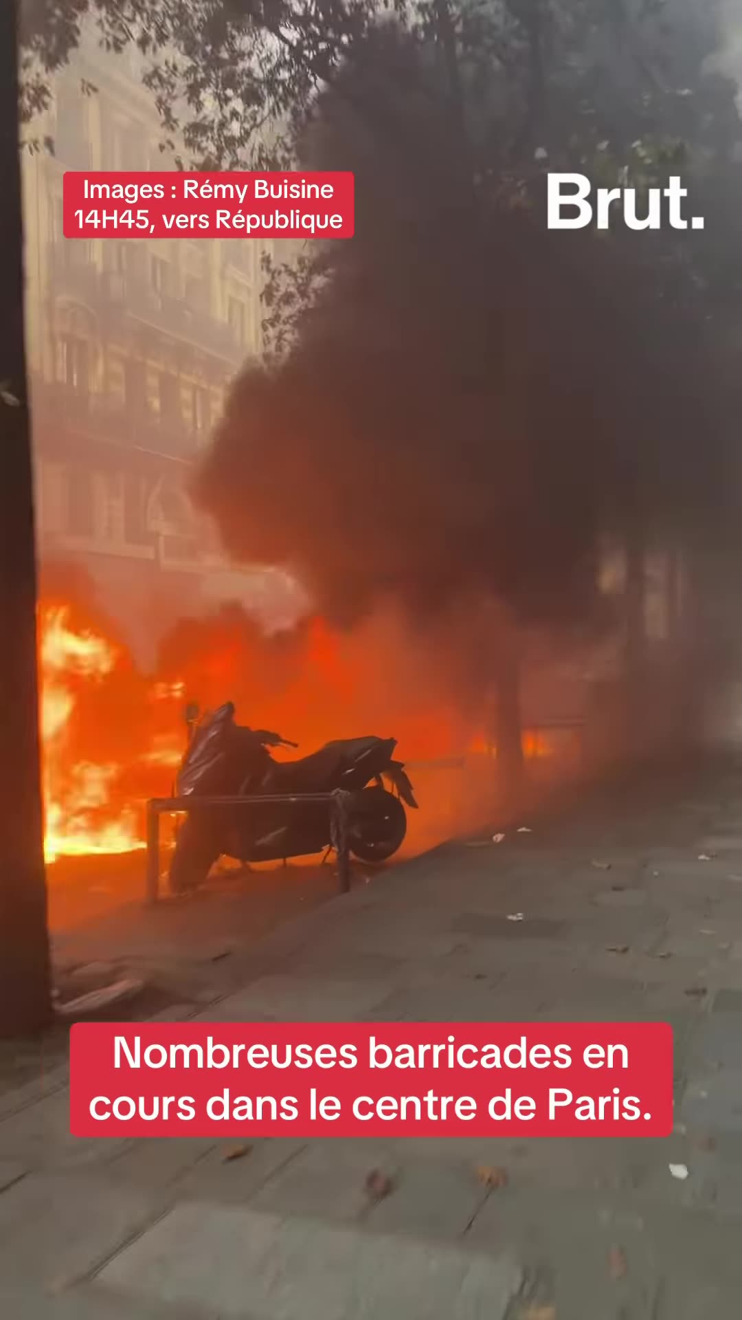 A Brut. reel, reshared by the owner, shows footage by Rémy Buisine of barricades and fires in central Paris near République. Police charge through smoke and tear gas while protesters flee.