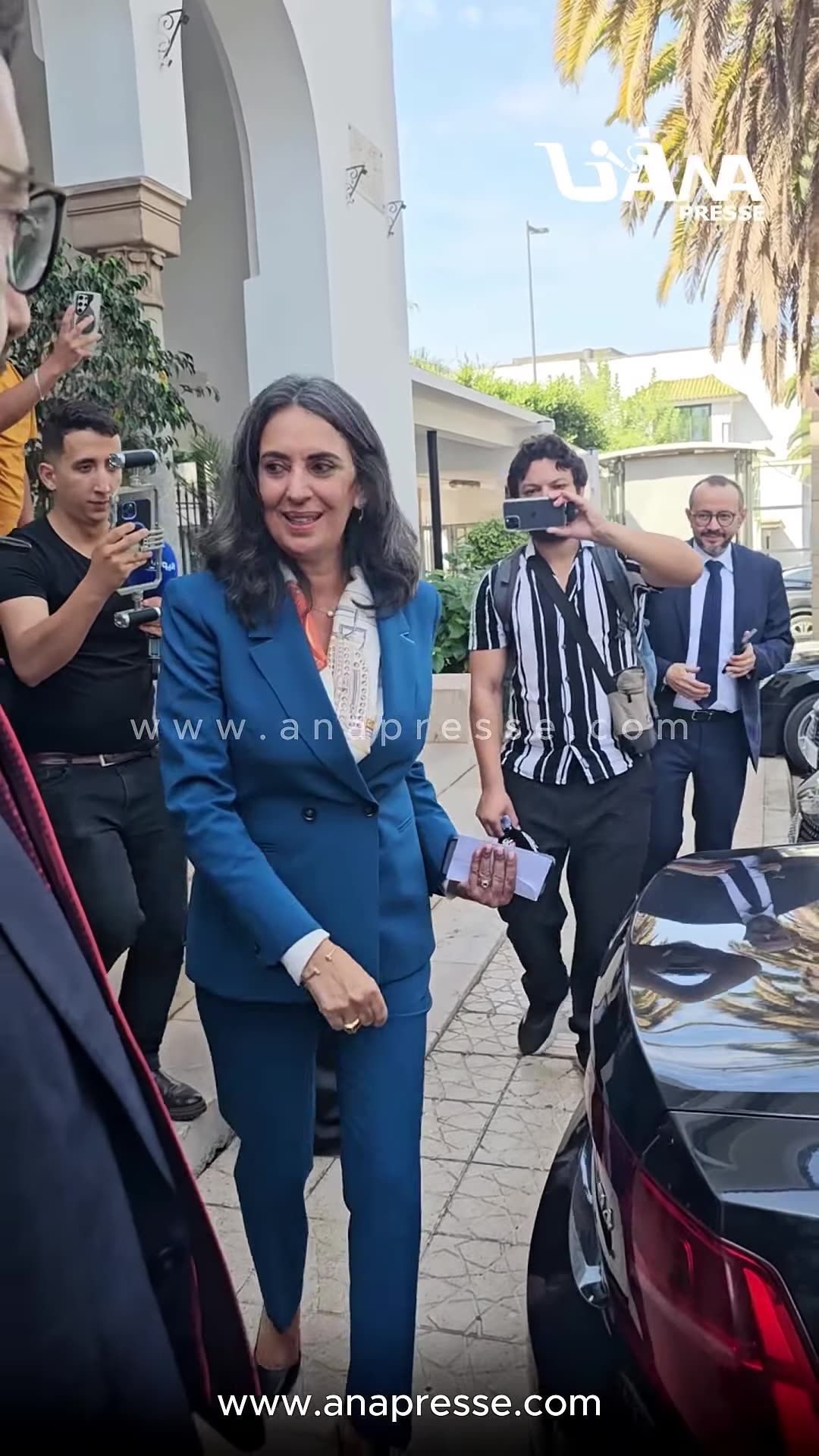 ANAPRESSE footage reshared by the owner shows Nadia Fettah leaving the Moroccan finance ministry after the handover of power. She hugs and greets staff and officials outside the building, shakes hands, and gets into a black car amid press.