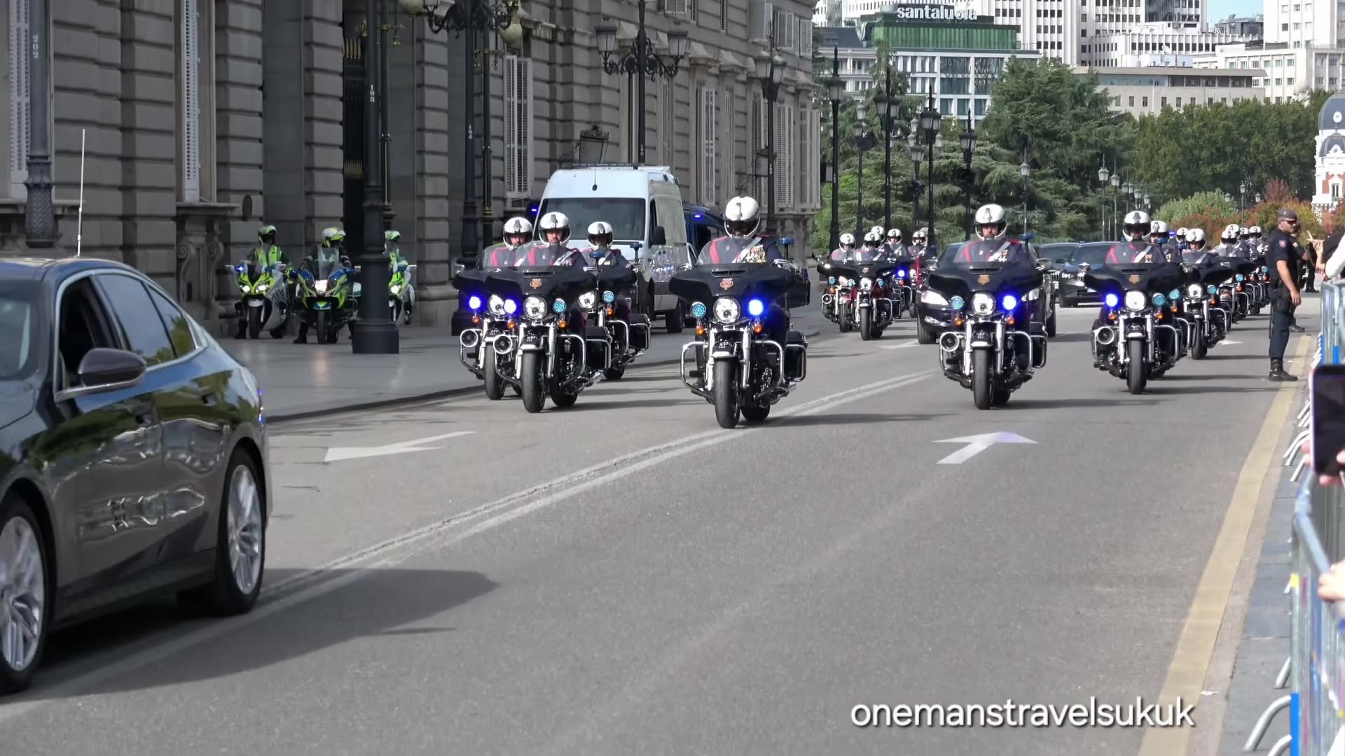 A reshared reel by onemantravelsuk of the motorcade of King Felipe VI leaving the Royal Palace in Madrid, escorted by police cars, motorcycle outriders and Royal Guard vehicles after the National Day parade engagement.