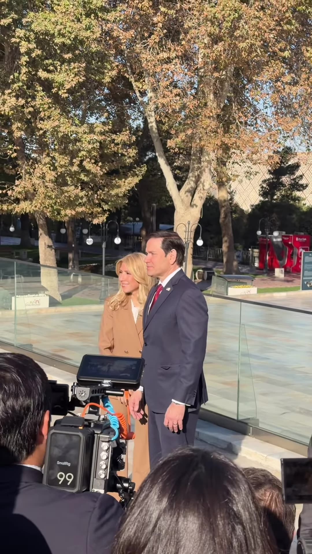 A reshared reel of US Secretary of State Marco Rubio and a companion visiting the Registan complex in Samarkand before the C5+1 event. A reporter with a ZAMON/Sevimli microphone speaks to camera, and crowds of press and security watch the visit.