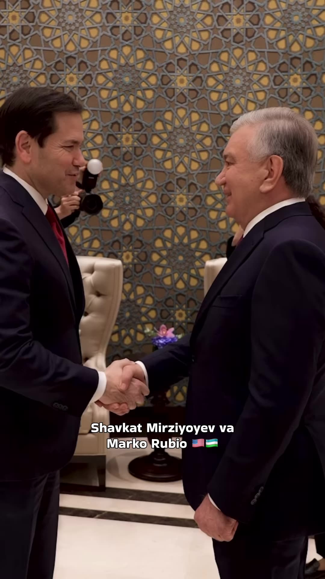 A reshared reel showing the handshake and greeting between Uzbek President Shavkat Mirziyoyev and US Secretary of State Marco Rubio in an ornate hall, with photographers filming and guards at the door.