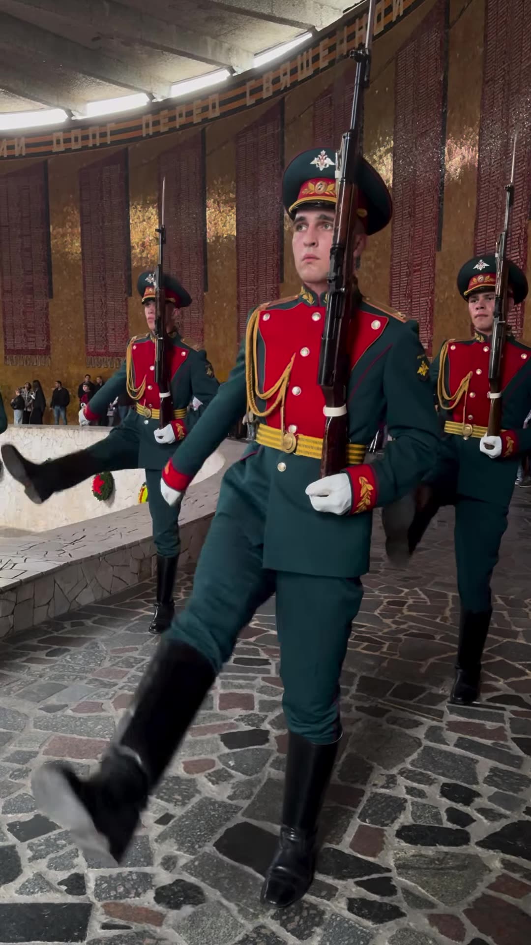 A repost of a reel showing the changing of the guard at the eternal flame in the Hall of Military Glory at the Motherland Calls memorial on Mamayev Kurgan in Volgograd. The soldiers march with high steps, present arms, and one sentry is relieved at the post. Video speed is x1.7.