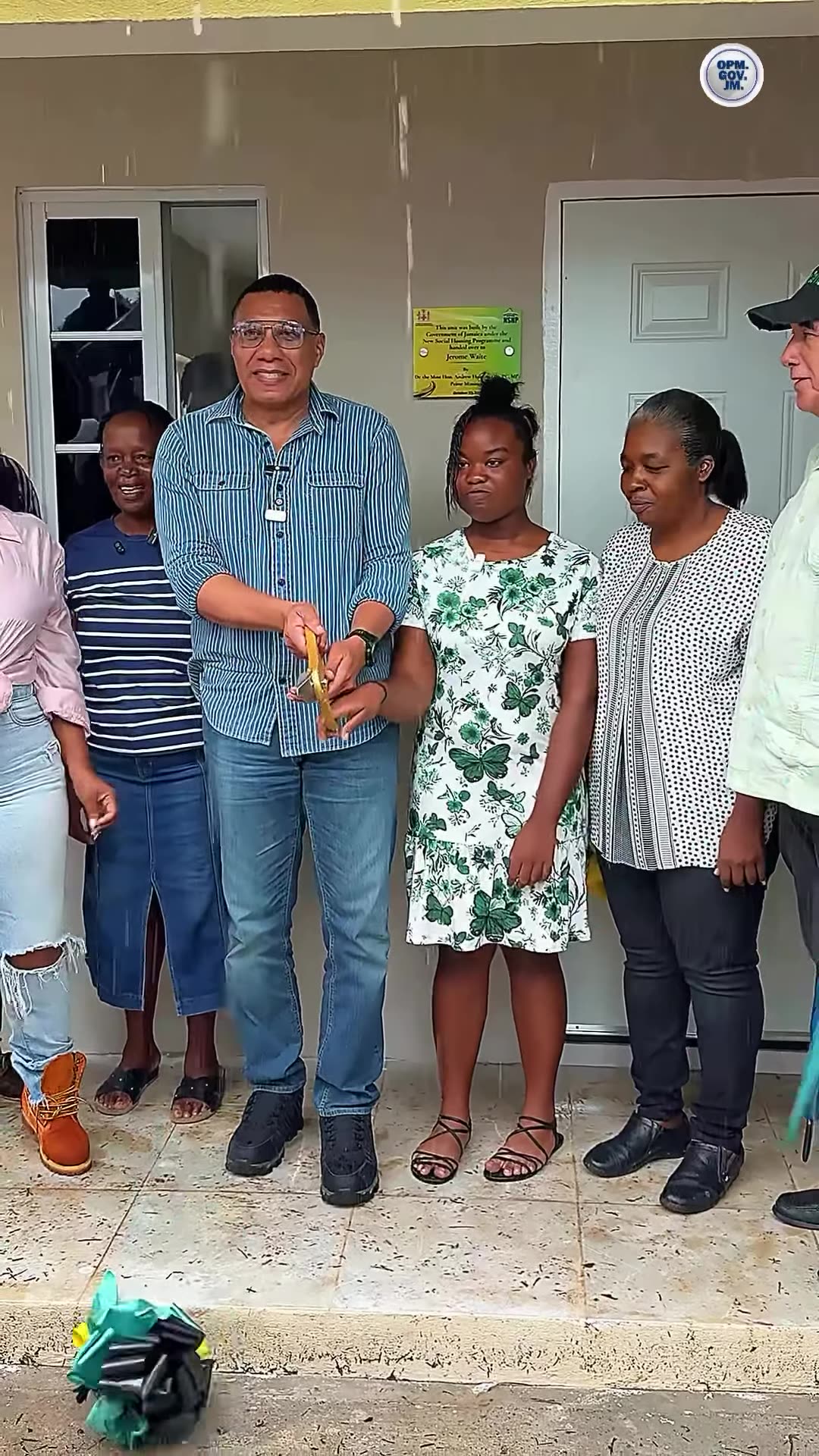 A repost of Andrew Holness's reel in which 17-year-old Olivia Waite tours her new home from the New Social Housing Programme and gives an emotional speech about losing her parents and her father's hope to secure a safe home for her. The video ends with a ribbon cutting at the front door of the hous…