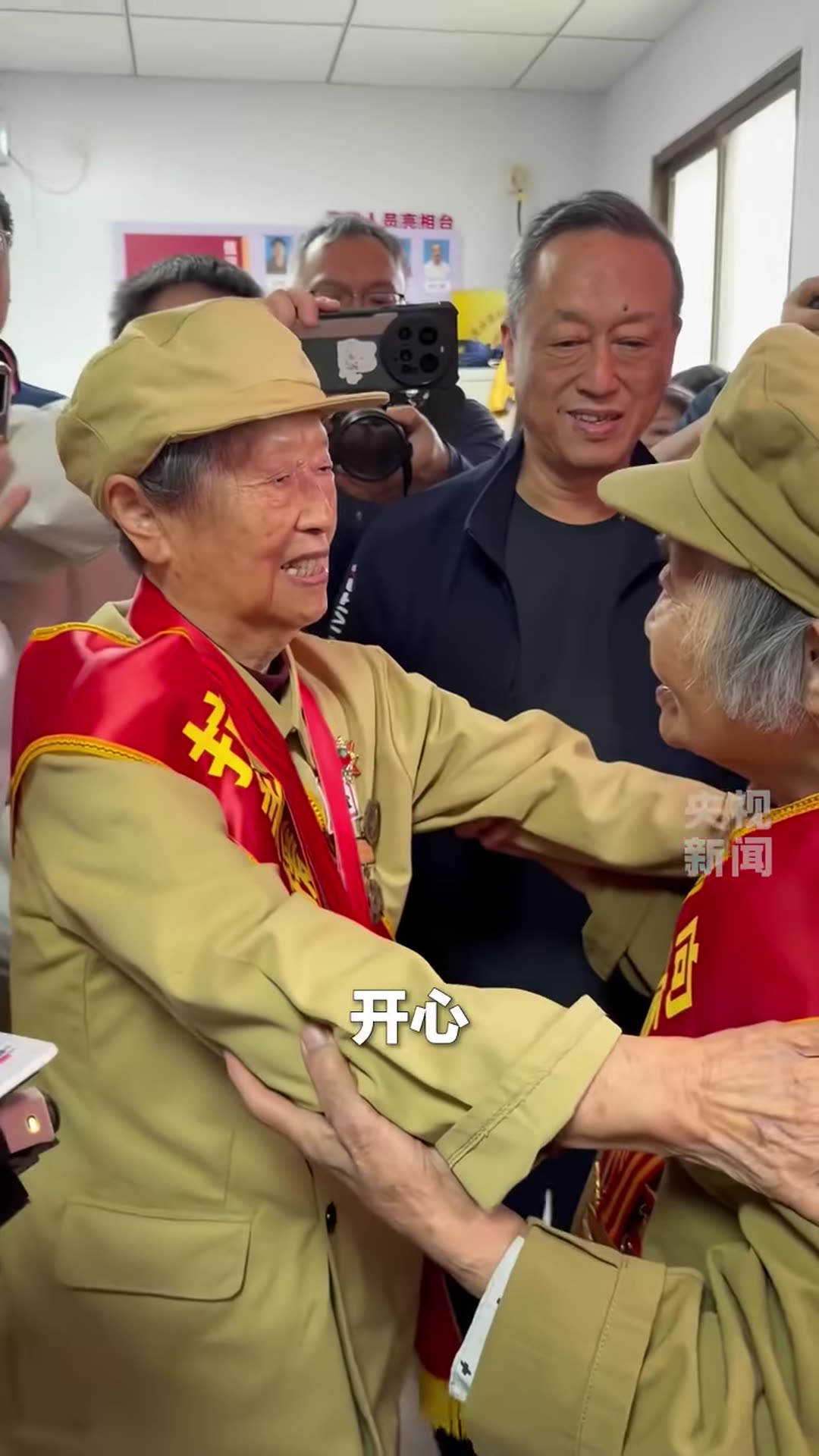 A repost of a CCTV reel showing two veterans in their nineties, both Chinese People's Volunteers veterans, meeting again after 72 years. An old photo helped them find each other, and the clip ends with one of them saluting the other.