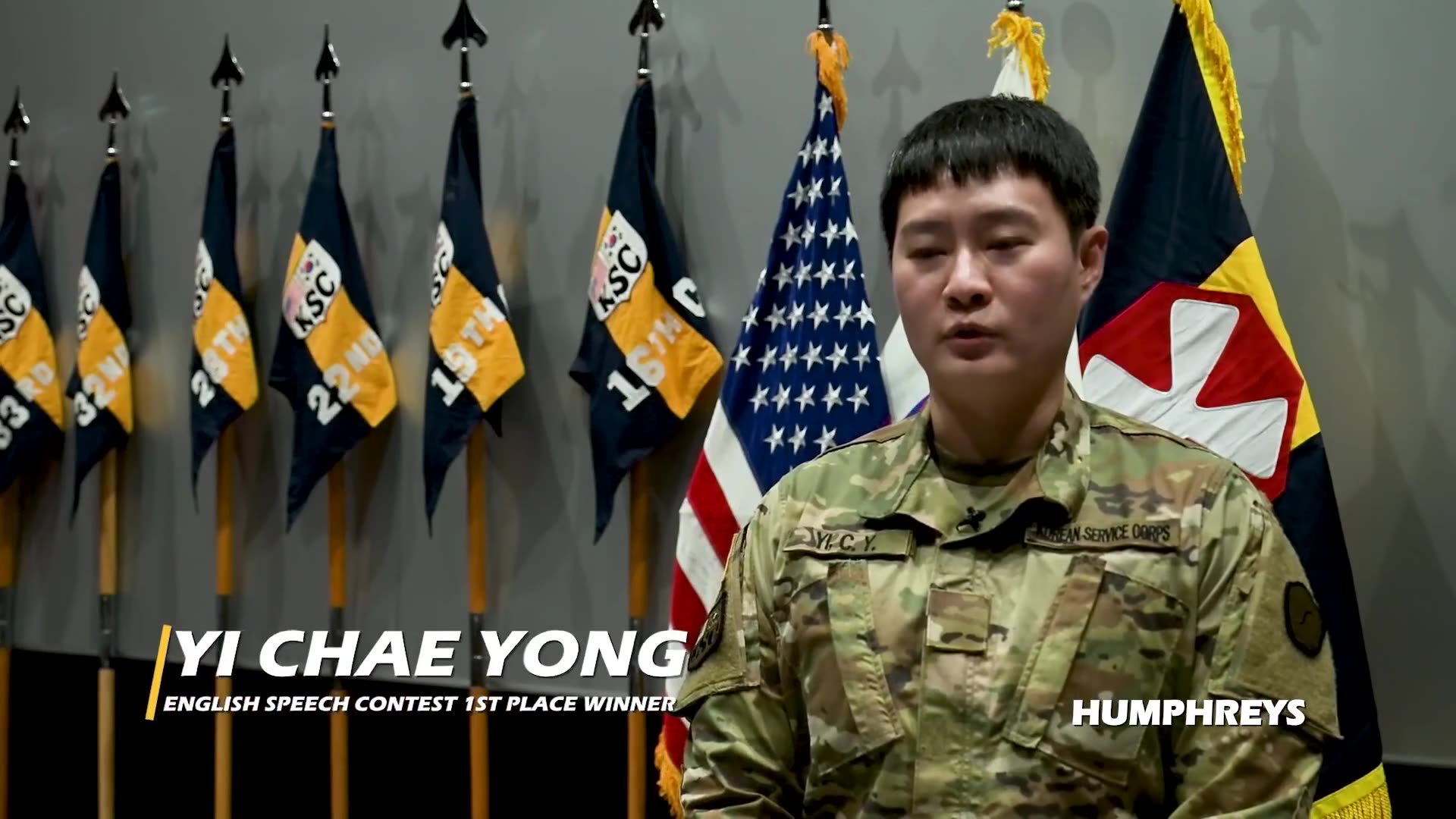 A short news-style video about an English speech contest for soldiers at a US Army garrison in South Korea, featuring interviews with participants and organizers and shots of the audience and stage.
